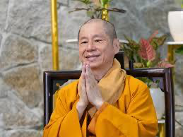 A person in a yellow robe
Description automatically generated